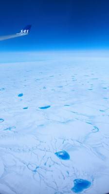 Large number of meltwater lakes on the glacier&#8217;s surface and the extensive network of stream channels crisscrossing the Greenland Ice Sheet